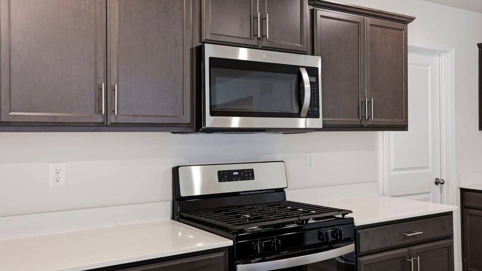 Kitchen and island with quartz countertops.