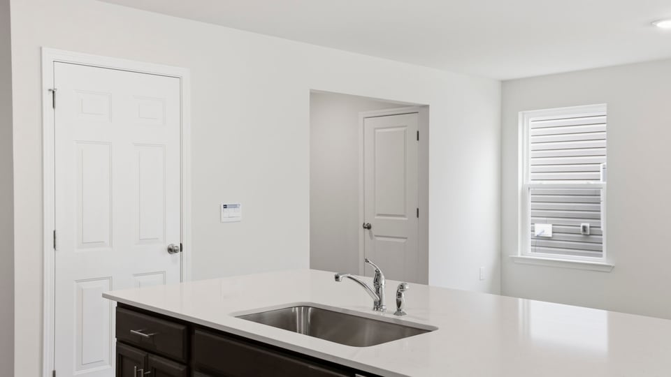 Kitchen and island with quartz countertops.