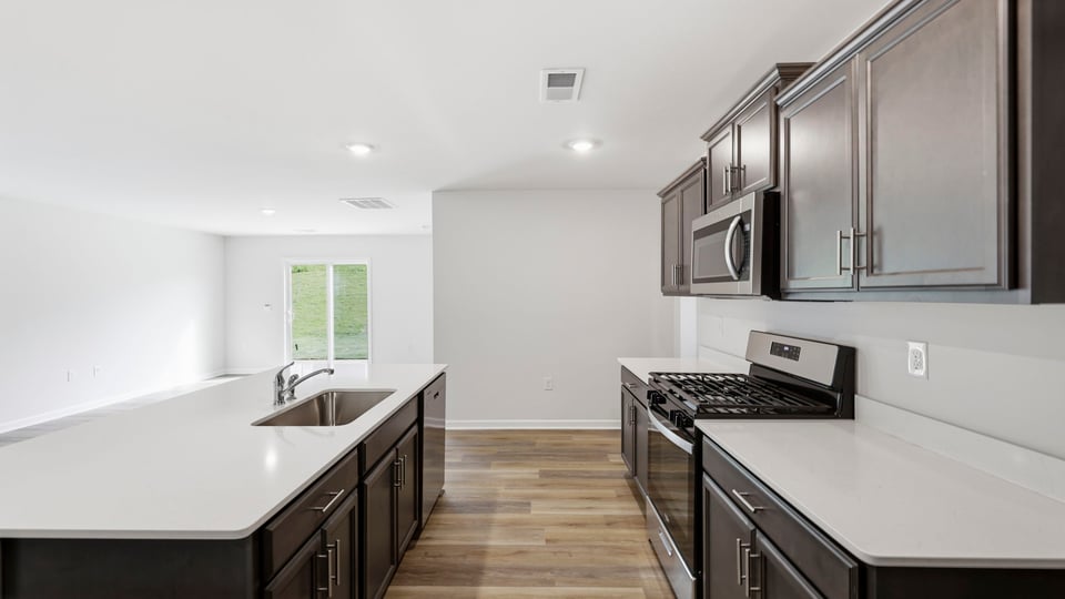 Kitchen and island with quartz countertops.