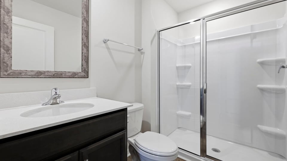 Bathroom with single vanity sink and walk in shower.