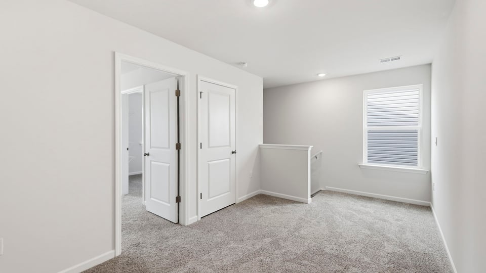 Loft area with carpet.