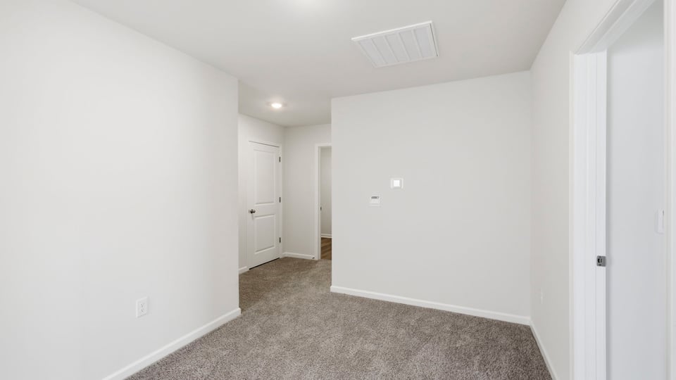 Bedroom with carpet and window.