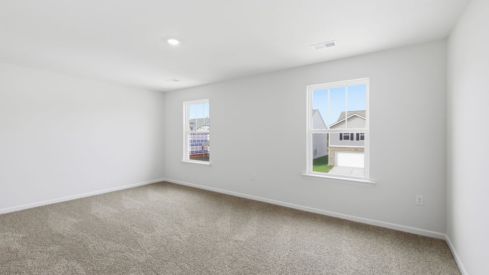 Bedroom with carpet and window.
