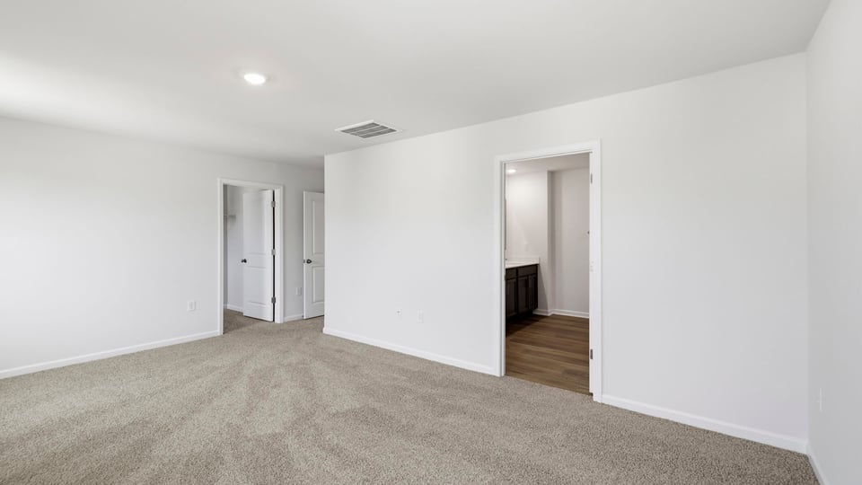Bedroom with carpet and window.