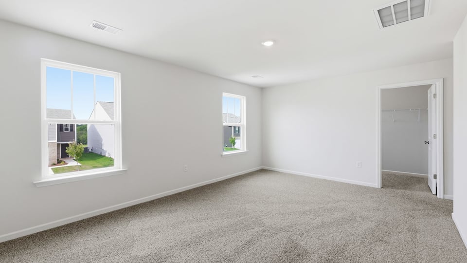Bedroom with carpet and window.