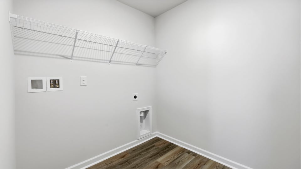 Laundry room with hanging storage racks.