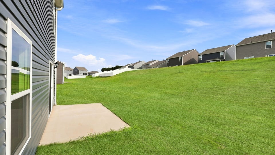Back exterior of home with patio.
