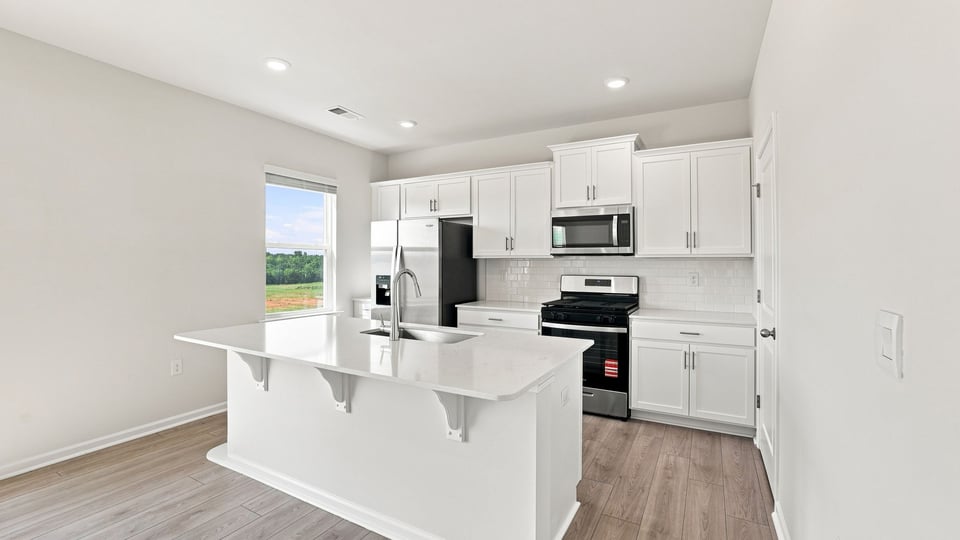 Kitchen with island and cabinets.