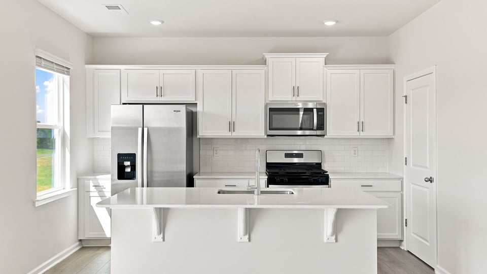 Kitchen with island and cabinets.