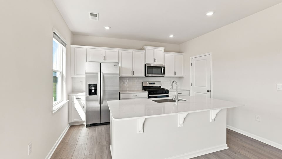 Kitchen with island and cabinets.
