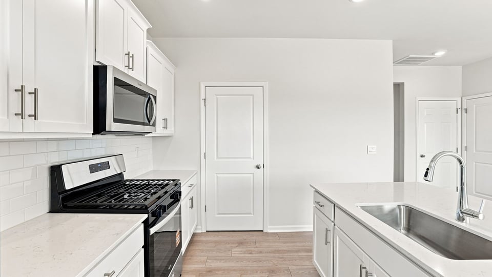 Kitchen with island and cabinets.