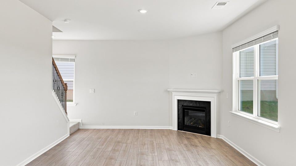 Living area with fireplace and windows.