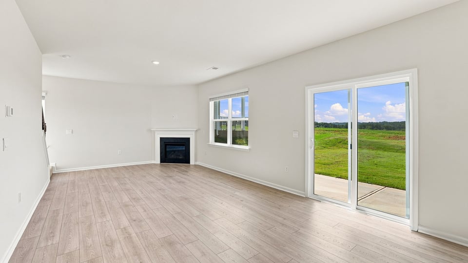 Living area with fireplace and windows.