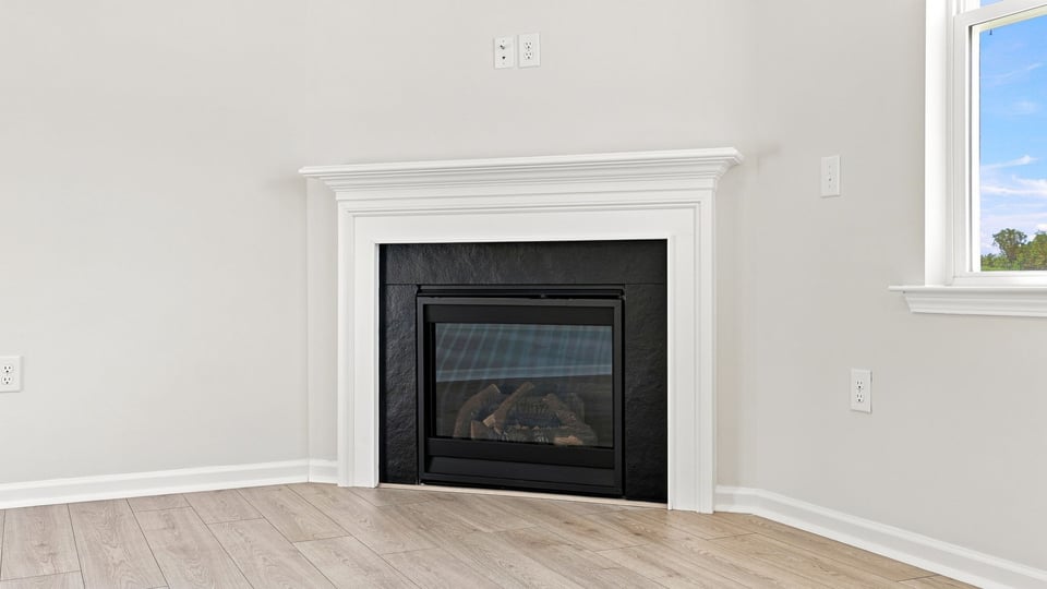 Living area with fireplace and windows.
