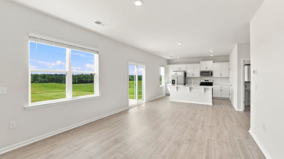 Living area with fireplace and windows.