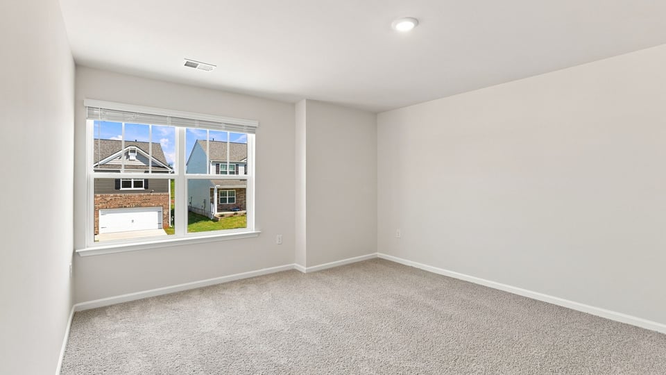 Bedroom with carpet and windows.