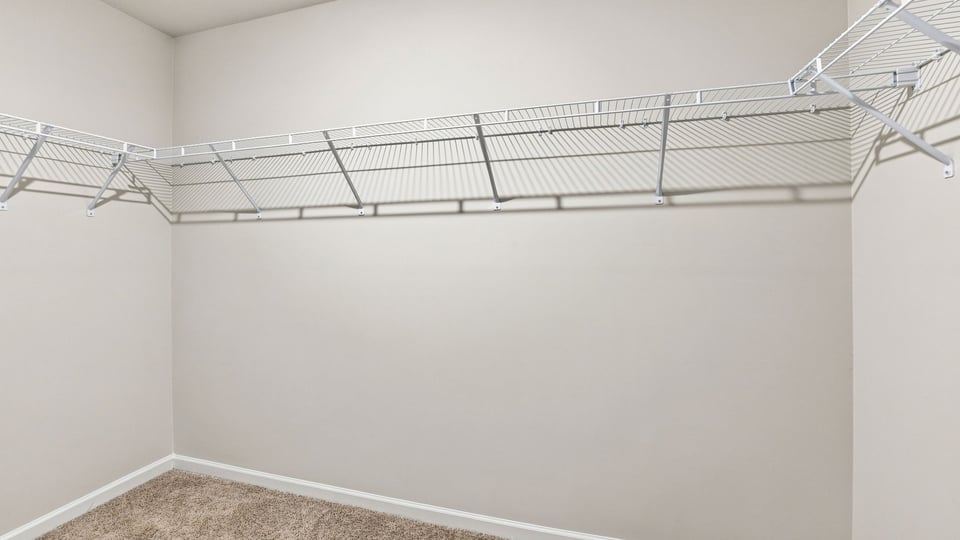 Primary closet with shelf.