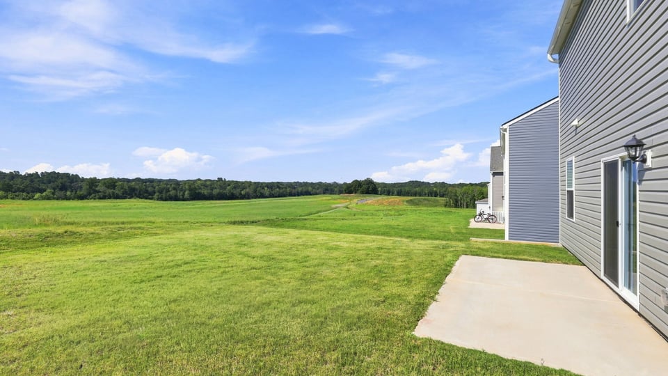Back exterior with large backyard.