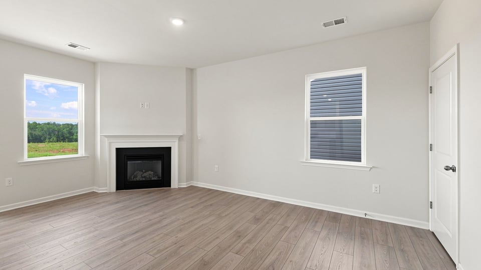 Living room with fireplace and windows.