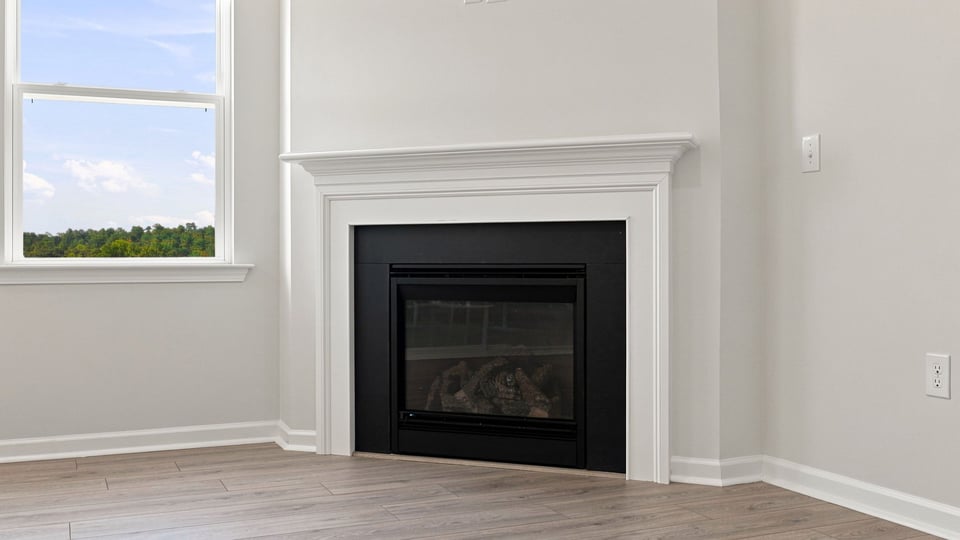 Living room with fireplace and windows.