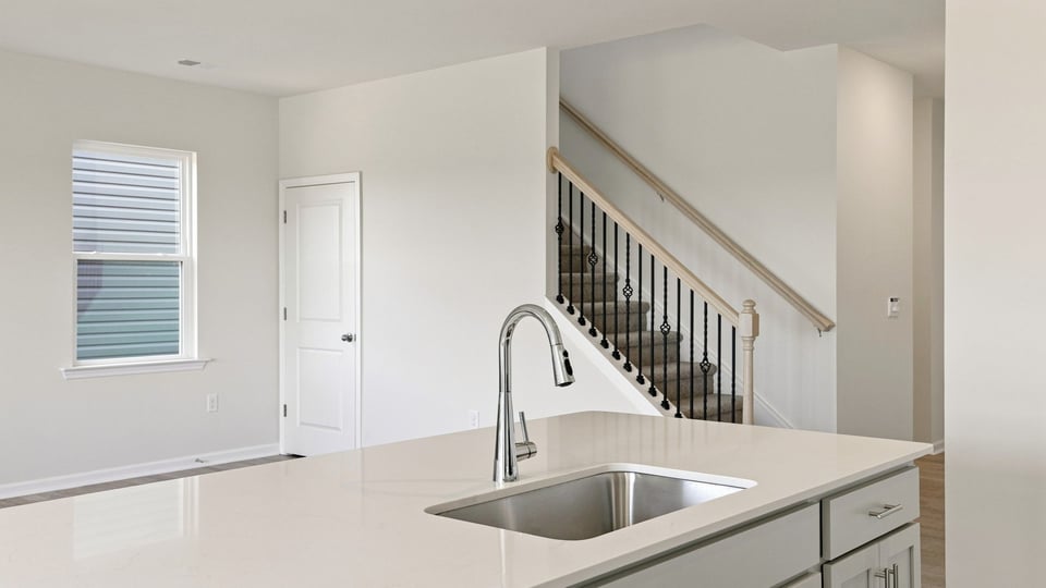 Kitchen and island with quartz countertops.
