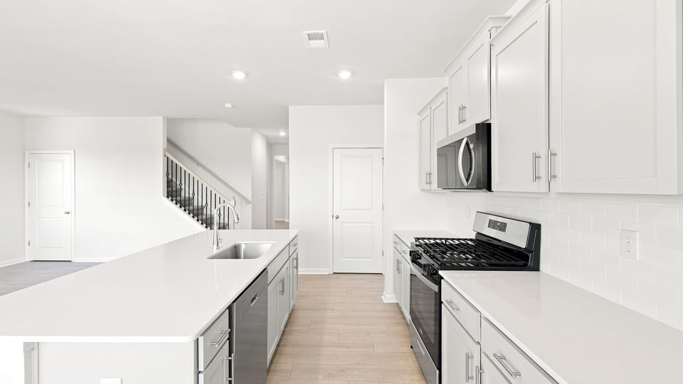 Kitchen and island with quartz countertops.