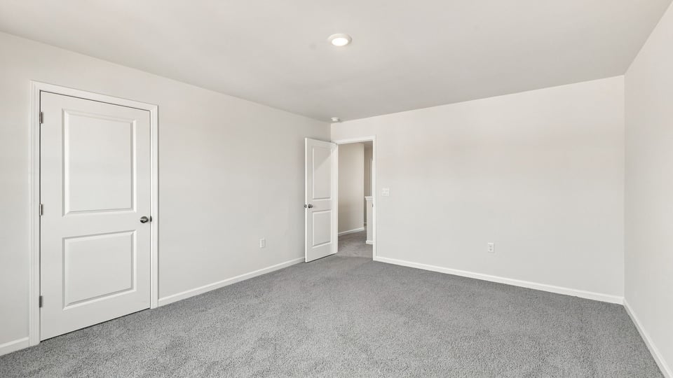 Bedroom with carpet and window.