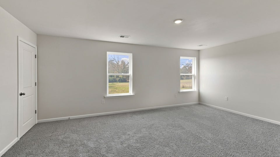 Bedroom with carpet and window.