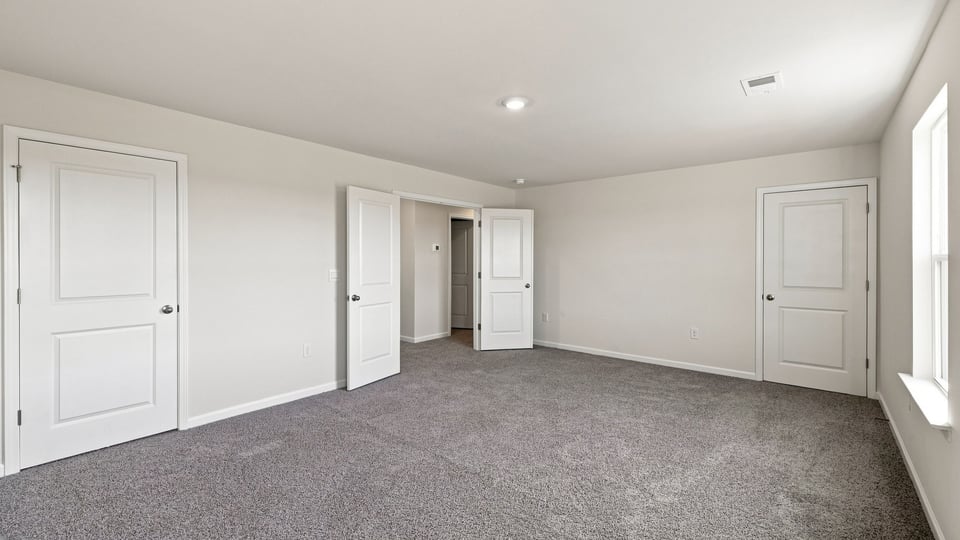 Bedroom with carpet and window.