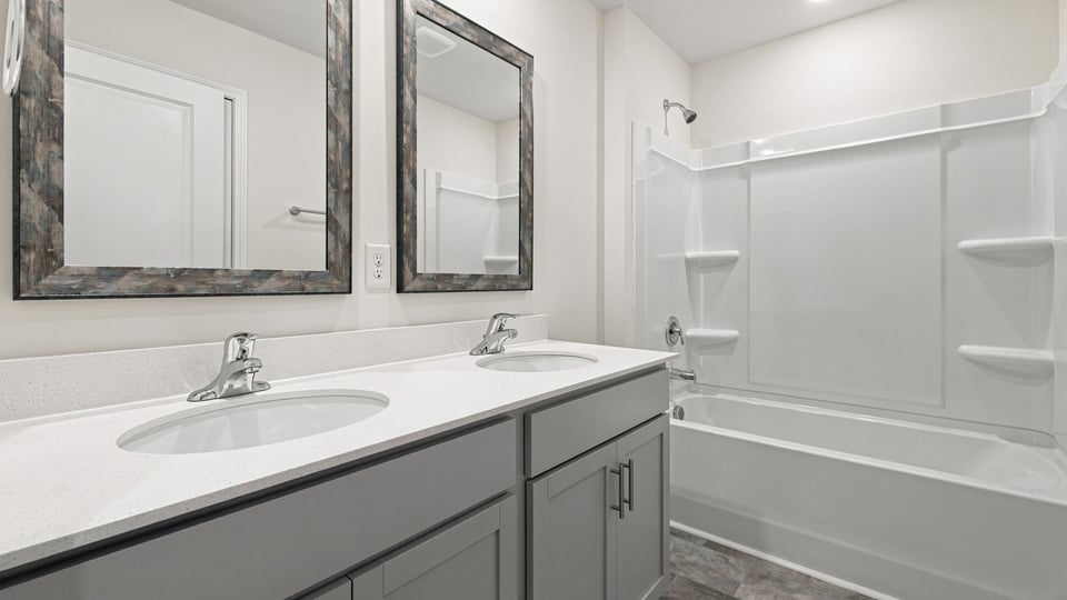 Bathroom with double vanity sink and bathtub.