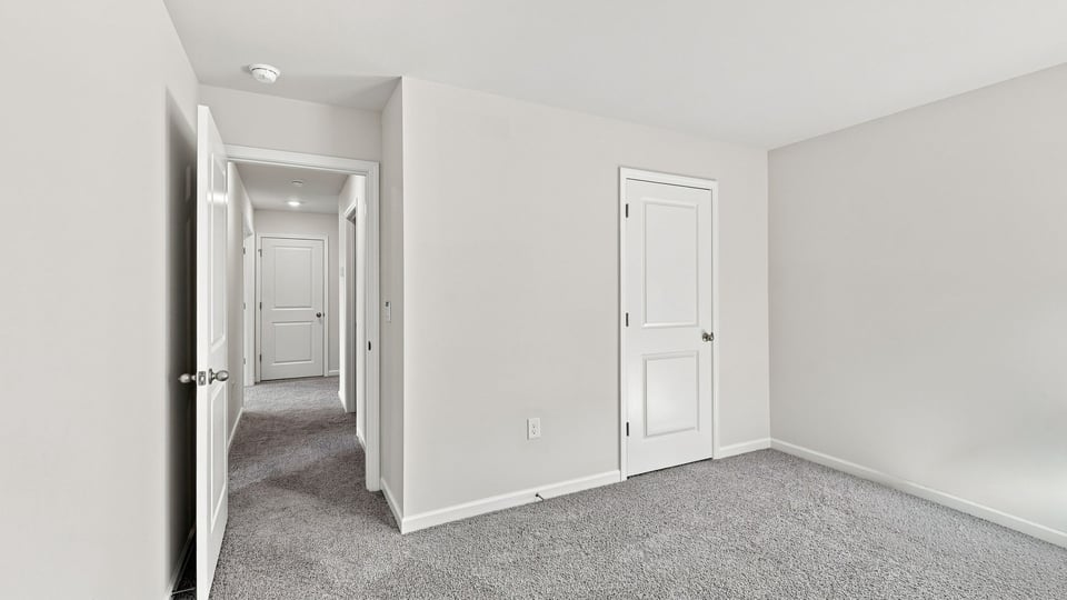 Bedroom with carpet and window.
