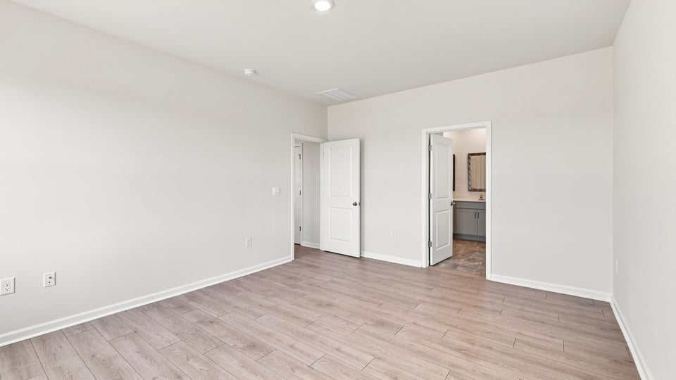 Bedroom with carpet and window.