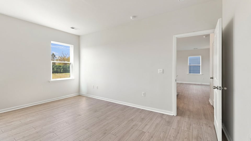 Bedroom with carpet and window.