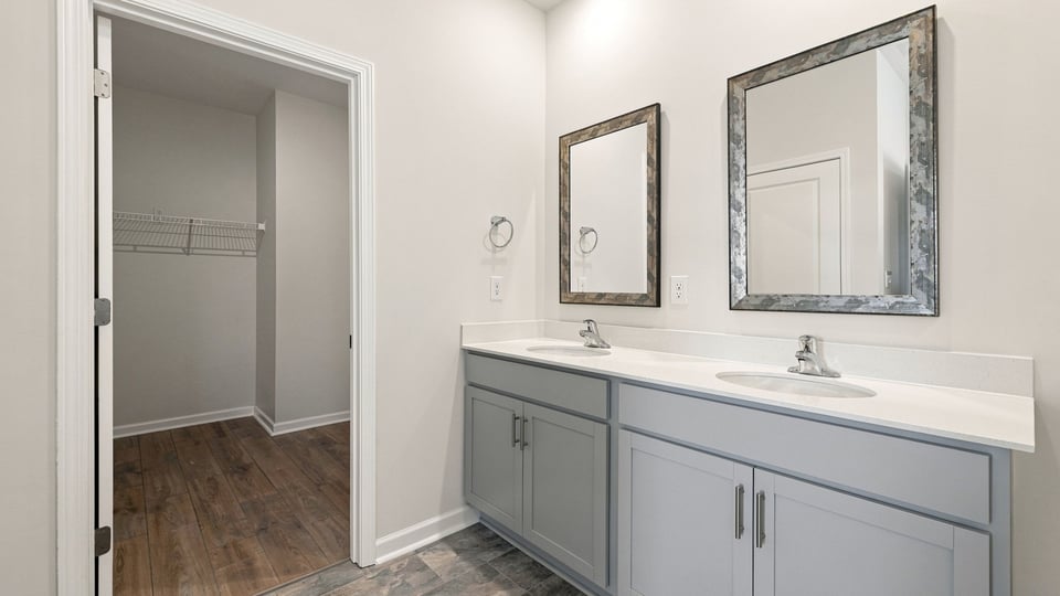 Bathroom with double vanity sink and closet.