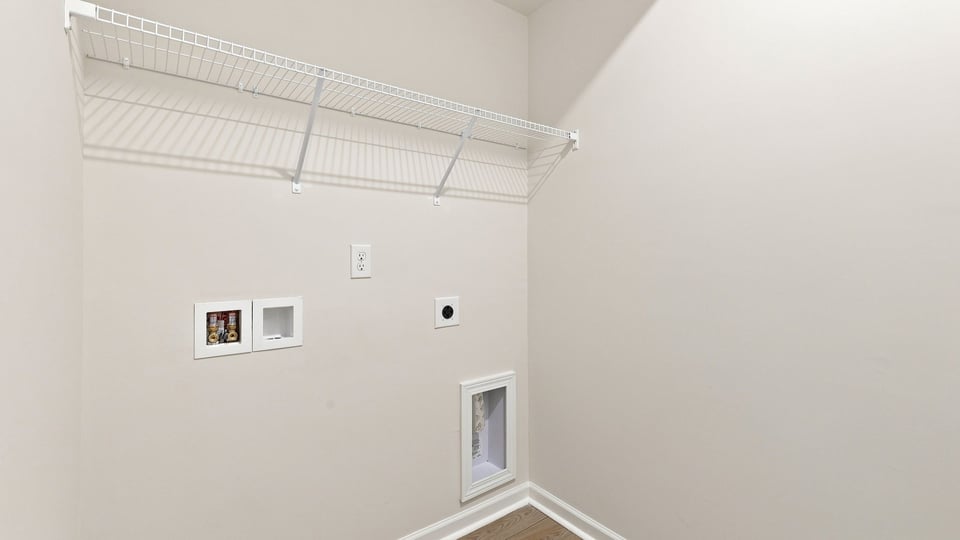 Laundry room with hanging storage racks.