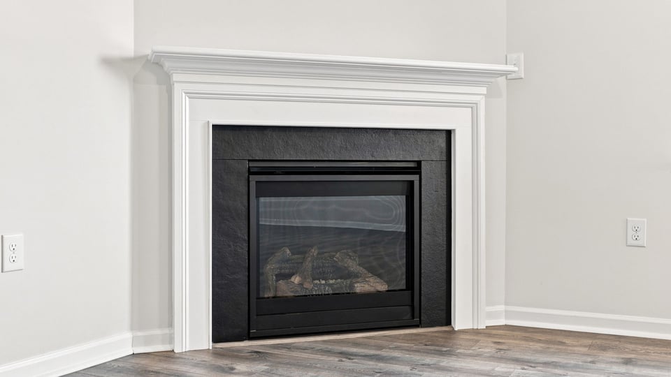 Living area with windows and fireplace.