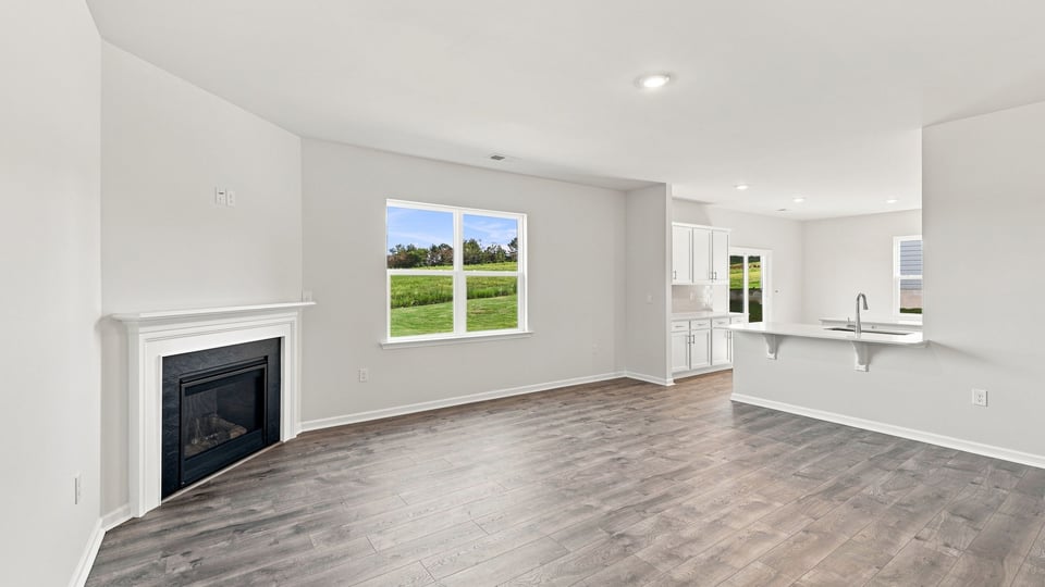 Living area with windows and fireplace.