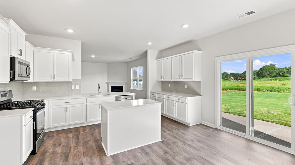 Kitchen with island and cabinets.