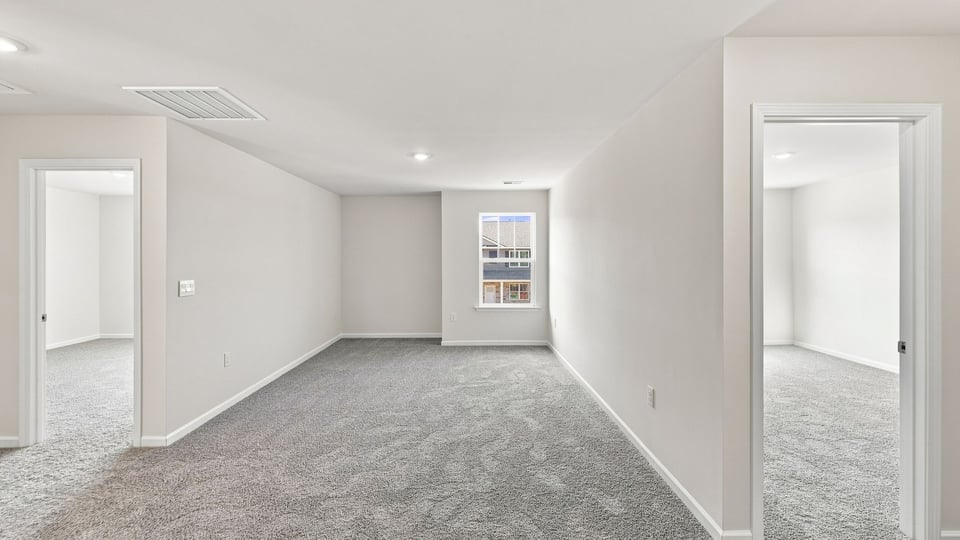 Loft with window and carpet.