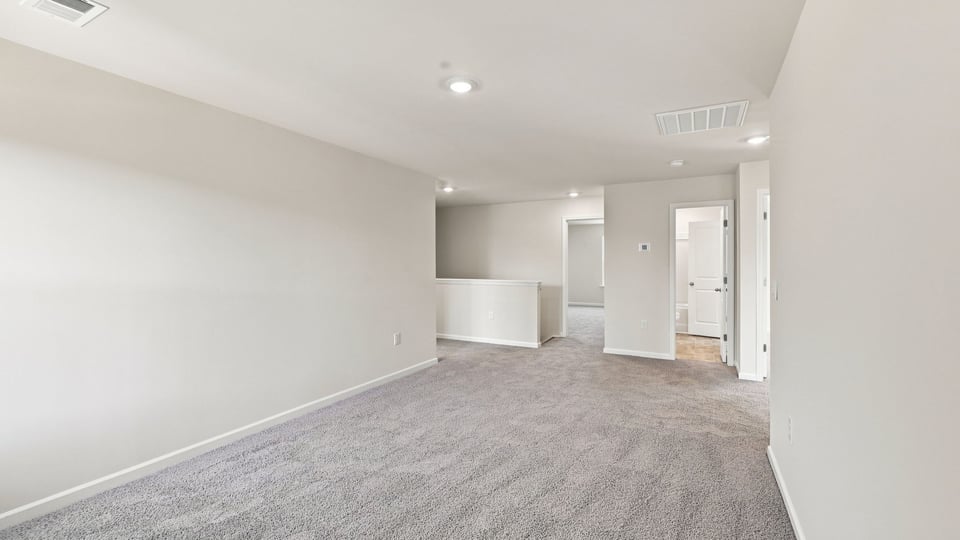 Loft with window and carpet.