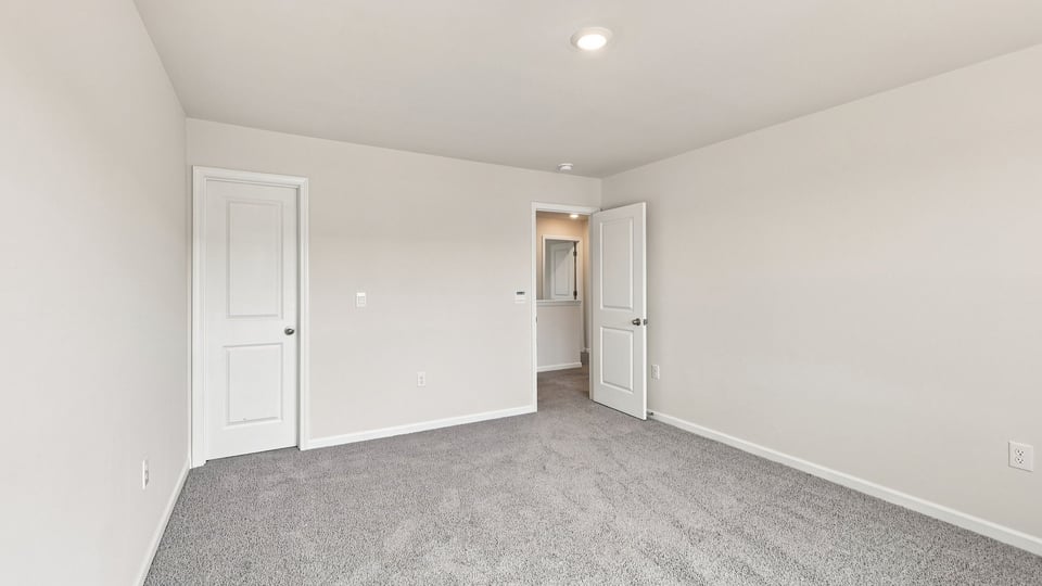 Bedroom with carpet and window.
