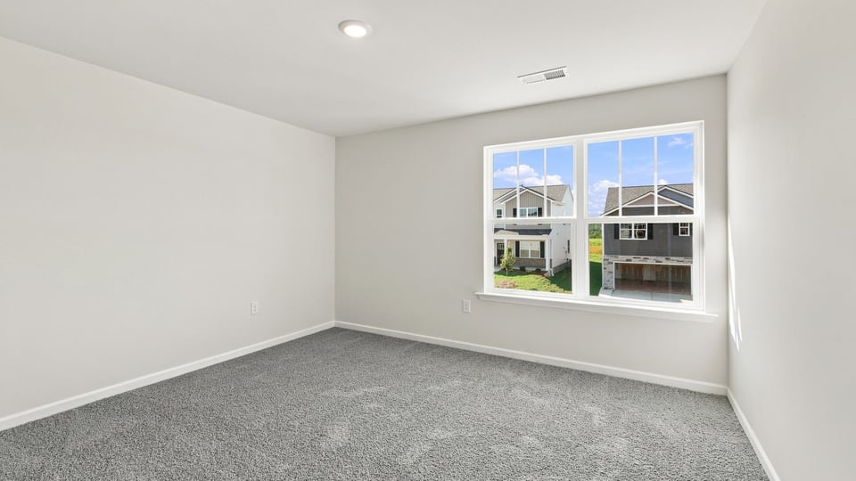 Bedroom with carpet and window.