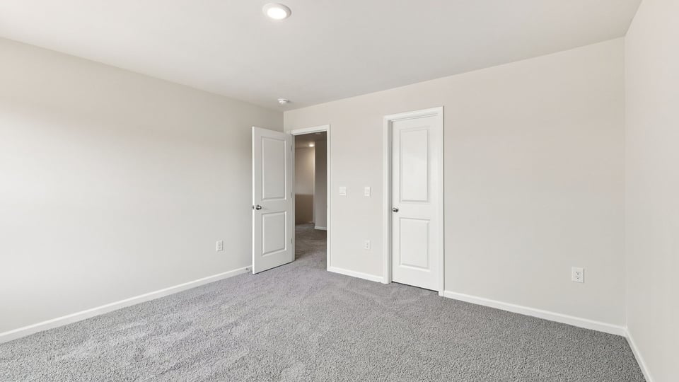 Bedroom with carpet and window.