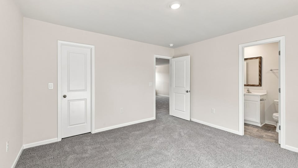 Bedroom with carpet and window.