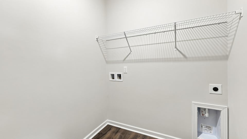 Laundry room with shelf.