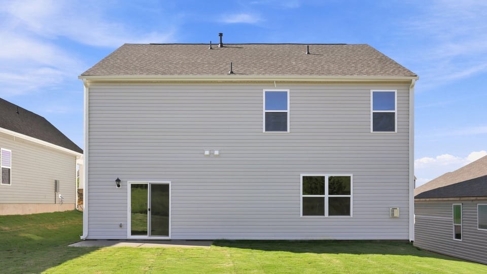 Back exterior with large backyard.