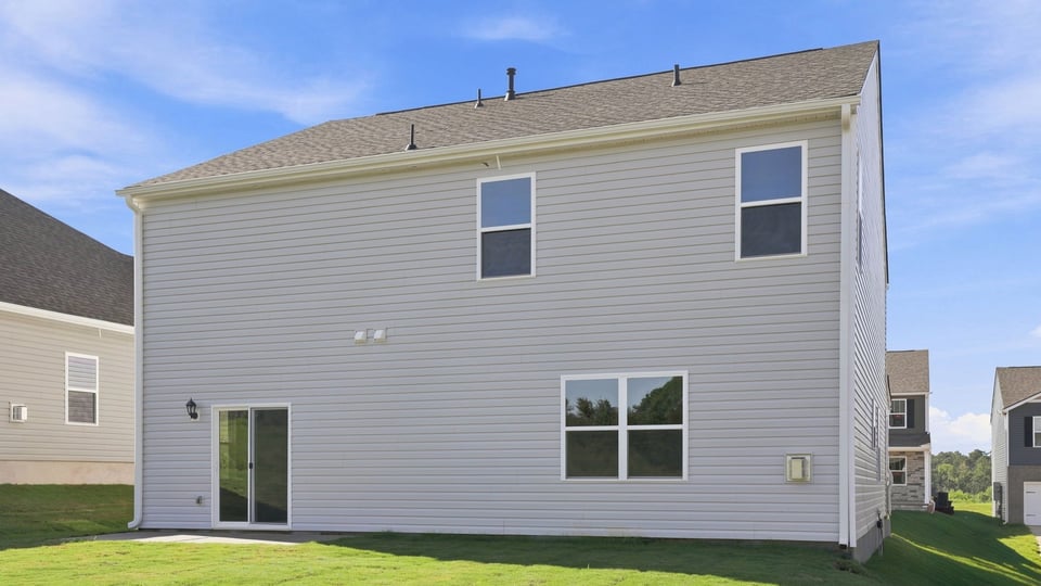 Back exterior with large backyard.