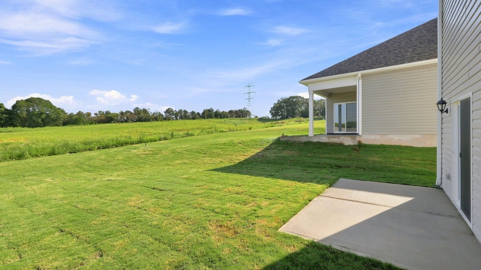 Back exterior with large backyard.
