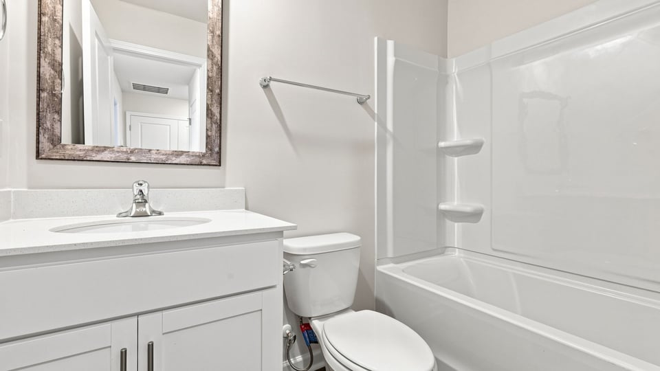 Bathroom with single vanity sink and bathtub.