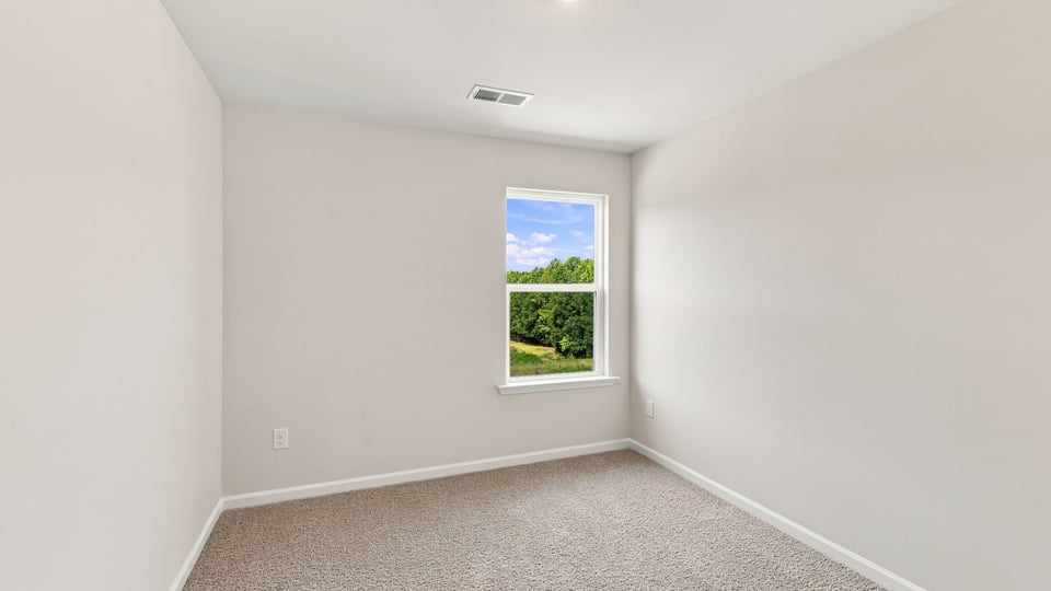 Bedroom with carpet and window.